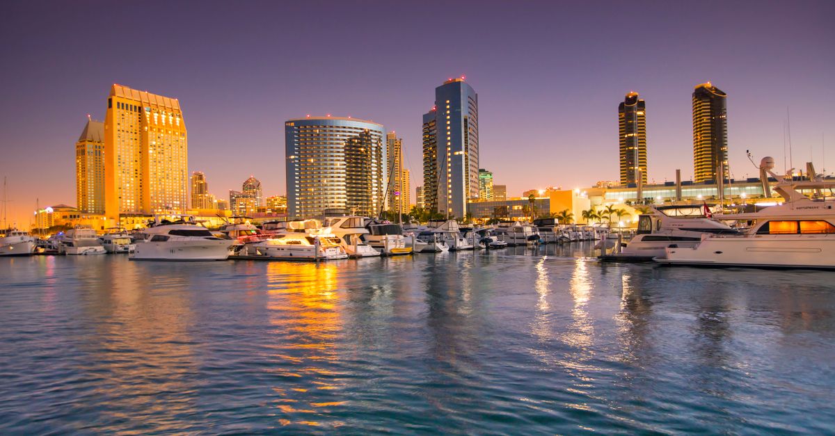 Breathtaking view of San Diego skyline at sunset with yachts in the harbor.